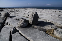Boulders lie on a limestone section near Black Head with Atlantic behind.Eire European Irish Northern Europe Republic Ireland Poblacht na hEireann Blue Gray Karst Sedimentary Rock Scenic