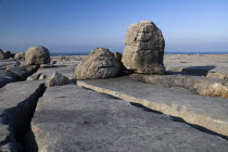 Boulders lie on a limestone section near Black Head with Atlantic behind.Eire European Irish Northern Europe Republic Ireland Poblacht na hEireann Blue Gray Karst Sedimentary Rock Scenic