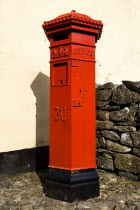 Red Post Pillar Box in 19th centuray village street.Eire European Irish Northern Europe Republic Ireland Poblacht na hEireann