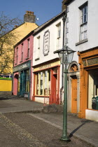 The Village Street denotes village life in 19th century Ireland  Gaslamp outside shops with traditional fronts.Eire European Irish Northern Europe Republic Ireland Poblacht na hEireann Blue Classic C...