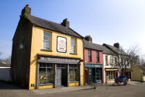 The Village Street denotes village life in 19th century Ireland  McInerney & Sons ironmongers shop.Eire European Irish Northern Europe Republic Ireland Poblacht na hEireann Blue History Historic Stor...
