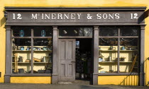 The Village Street denotes village life in 19th century Ireland  McInerney & Sons ironmongers shop.Eire European Irish Northern Europe Republic Ireland Poblacht na hEireann Gray History Historic Stor...