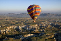 Turkey, Cappadocia, Goreme, Hot air balloons in flight over landscape, Hot air balloon glides away from Love Valley.