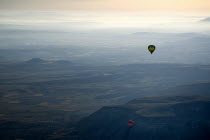 Turkey, Cappadocia, Goreme, Hot air balloons in flight over the landscape in early morning light.