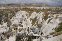 Turkey, Cappadocia, Goreme, A cave hotel built into the hillside with the Red Valley behind.