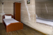 Turkey, Cappadocia, Goreme, Room with bed in typical cave hotel.