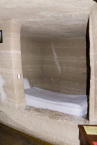 Turkey, Cappadocia, Goreme, Room with bed in typical cave hotel.