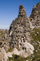 Turkey, Cappadocia, Uchisar Castle is a huge volcanic rock outcrop riddled with tunnels and dovecoate windows.