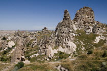 Turkey, Cappadocia, Uchisar Castle is a huge volcanic rock outcrop riddled with tunnels and dovecoate windows.