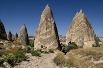 Turkey, Cappadocia, Goreme, Sword Valley, The valley got its name because of all the sharp pinnacles to be found there. The hilltop town of Uchisar can be seen in the background.