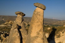 Turkey, Cappadocia, Goreme, Urgup, Fairy Chimneys with their hats on, Mount Erciyes in the background.