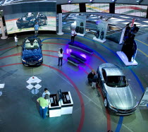 Germany, Bavaria, Munich, BMW Welt, World, People in showroom examining BMW cars.