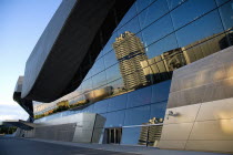 Germany, Bavaria, Munich, BMW Headquarters and museum reflected in BMW Welt, World.
