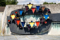 Germany, Bavaria, Munich, Dachau World War II Nazi Concentration Camp Prisoner badges memorial, Communists were given red triangles, Jews yellow ones and foreign workers got the blue triangle.