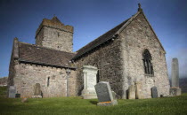 St. Clements Church with gravestones in the cemetary in the foreground.European Alasdair CrotachAlexander VII of Harris Alba Blue Gray Great Britain Northern Europe Religion Religious UK United King...