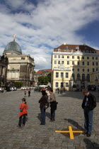 Nuemarkt  Tourist  looking a yellow crosses put on manhole covers after security checks for President Barack Obama visited.Destination Destinations Deutschland European History Holidaymakers Sachsen...