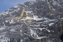 Canada, Alberta, Kananaskis Country, A light sprinkling of snow makes it easier to see the complex rock formation of the south face of Mount Evan Thomas.