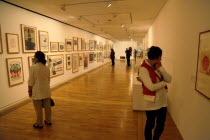 England, East Sussex, Bexhill on Sea, De La Warr Pavilion. Interior of the Art Deco Gallery and Arts Centre. People in gallery looking at exhibition of posters by Joseph Beuys.