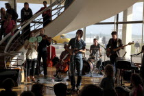 England, East Sussex, Bexhill on Sea, De La Warr Pavilion. Interior of the Art Deco Gallery and Arts Centre. Band performance under the stairwell from the Wilkomen Collective group including the Leisu...