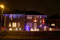 England, West Sussex, Southwick, Cul de Sac of house decorated with fairy lights for Christmas.