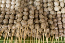 Thailand, Chiang Mai, Close up of pork meat balls on wooden skewers in the market.