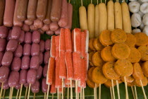 Thailand, Chiang Mai, Close up of a selection of food on wooden skewers in the market.