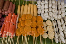 Thailand, Chiang Mai, Close up of a selection of food on wooden skewers in the market.