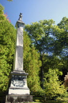 USA New York, Cooperstown, Local cemetary monument to James Fenimore Cooper topped with statue of Natty Bumpo, hero of "Leatherstocking Tales".