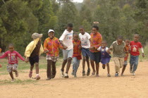 Botswana, School Children running on dirt road.