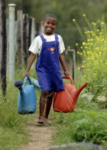 Swaziland, Young Girl Collecting water  with watering cans.