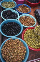 France, Aquitaine, Issigeac, Varieties of olives in bowls for sale in weekly Sunday market.