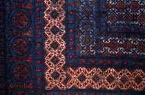 India, Rajasthan, Colourful red black blue and white patterned textile block print on cloth fabric.