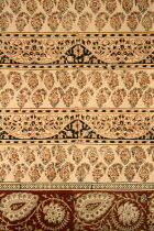 India, Rajasthan, Colourful red black and cream patterned textile block print on cloth fabric.