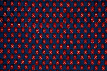 India, Rajasthan, Colourful red black blue and white patterned textile block print on cloth fabric.