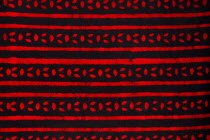 India, Rajasthan, Colourful red and black patterned textile block print on cloth fabric.