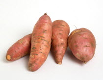 USA, Food, Root Vegetables, Group shot of North American sweet potatoes on a white background.