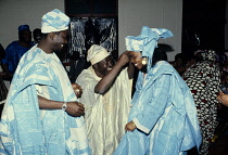 Nigeria, Religion, Weddings, Bride and Groom at traditional wedding, wearing traditional clothing.
