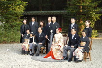 Japan, Tokyo, Yoyog, Meiji Jingu shrine, wedding ceremony, bride and groom about thirty years old, in traditional kimono, flanked by familys.