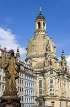 GERMANY, Saxony, Dresden, The restored Baroque church of Frauenkirch Church of Our Lady and surrounding restored buildings in Neumarkt with a statue in the foreground.
