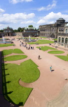 GERMANY, Saxony, Dresden, The central Courtyard of the restored Baroque Zwinger Palace gardens busy with tourists originally built between 1710 and 1732 after a design by Matthus Daniel Pppelmann in...