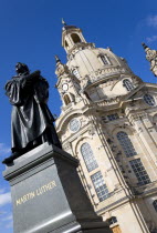 GERMANY, Saxony, Dresden, The restored Baroque church of Frauenkirch Church of Our Lady in Neumarkt square with a statue of Martin Luther in the foreground.