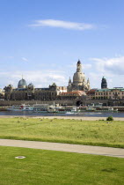 GERMANY, Saxony, Dresden, The city skyline with cruise boats moored on the River Elbe in front of the embankment buildings on the Bruhl Terrace busy with tourists of the Art Academy the restored Baroq...