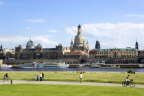 GERMANY, Saxony, Dresden, The city skyline with cruise boats moored on the River Elbe in front of the embankment buildings on the Bruhl Terrace busy with tourists of the Art Academy the restored Baroq...