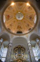 GERMANY, Saxony, Dresden, Interior of the restored Frauenkirche Church of Our Lady showing the central dome with murals and the organ.
