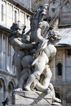 ITALY, Tuscany, Pisa, A statue of three Cherubs in front of the Duomo Cathedral in The Campo dei Miracoli or Field of Miracles.