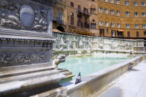 ITALY, Tuscany, Siena, The 19th Century replica of the 15th Century white marble Fonte Gaia fountain by the artist Jacopo della Quercia in the Piazza del Campo.