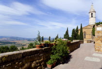 ITALY, Tuscany, Pienza, Val D'Orcia The belltower of the Duomo built in 1459 by the architect Rossellino for Pope Pius II seen from the Via Dell' Amore with cypress trees overlooking the countryside b...
