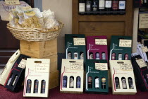 ITALY, Tuscany, Montalcino, Val D'Orcia Brunello di Montalcino Enoteca or wine shop with dispaly of boxed wines and pastas on the pavement around its entrance with prices in Euros.