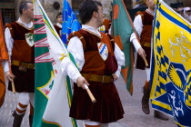 ITALY, Tuscany San, Gimignano, Procession of flag throwers in medieval costume through the streets of the Medieval hilltown.