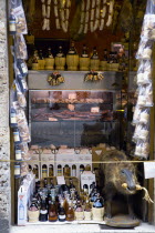 ITALY, Tuscany, San Gimignano, Shop display of chianti wines and wild boar products with a stuffed wild boar beside the wines.